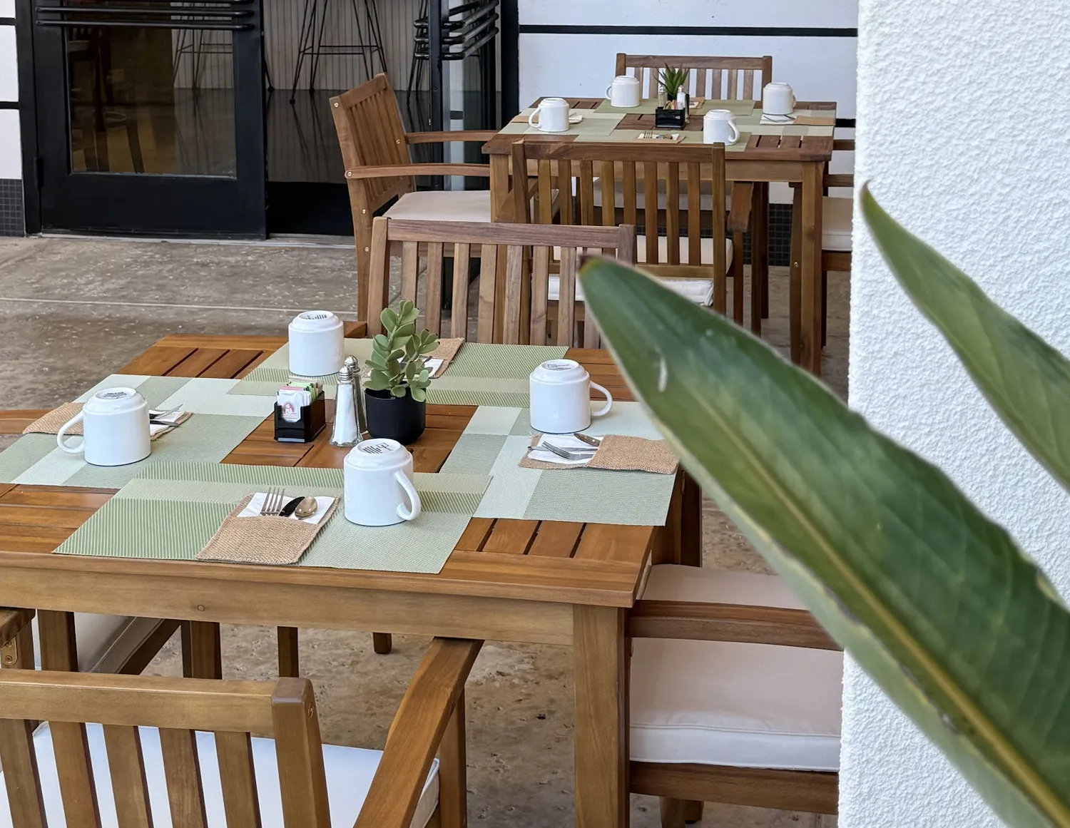 Alba’s patio tables set for breakfast at Coconut Point